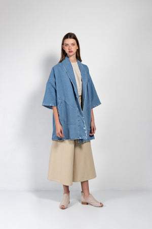 Women's distressed denim kimono in a medium wash
